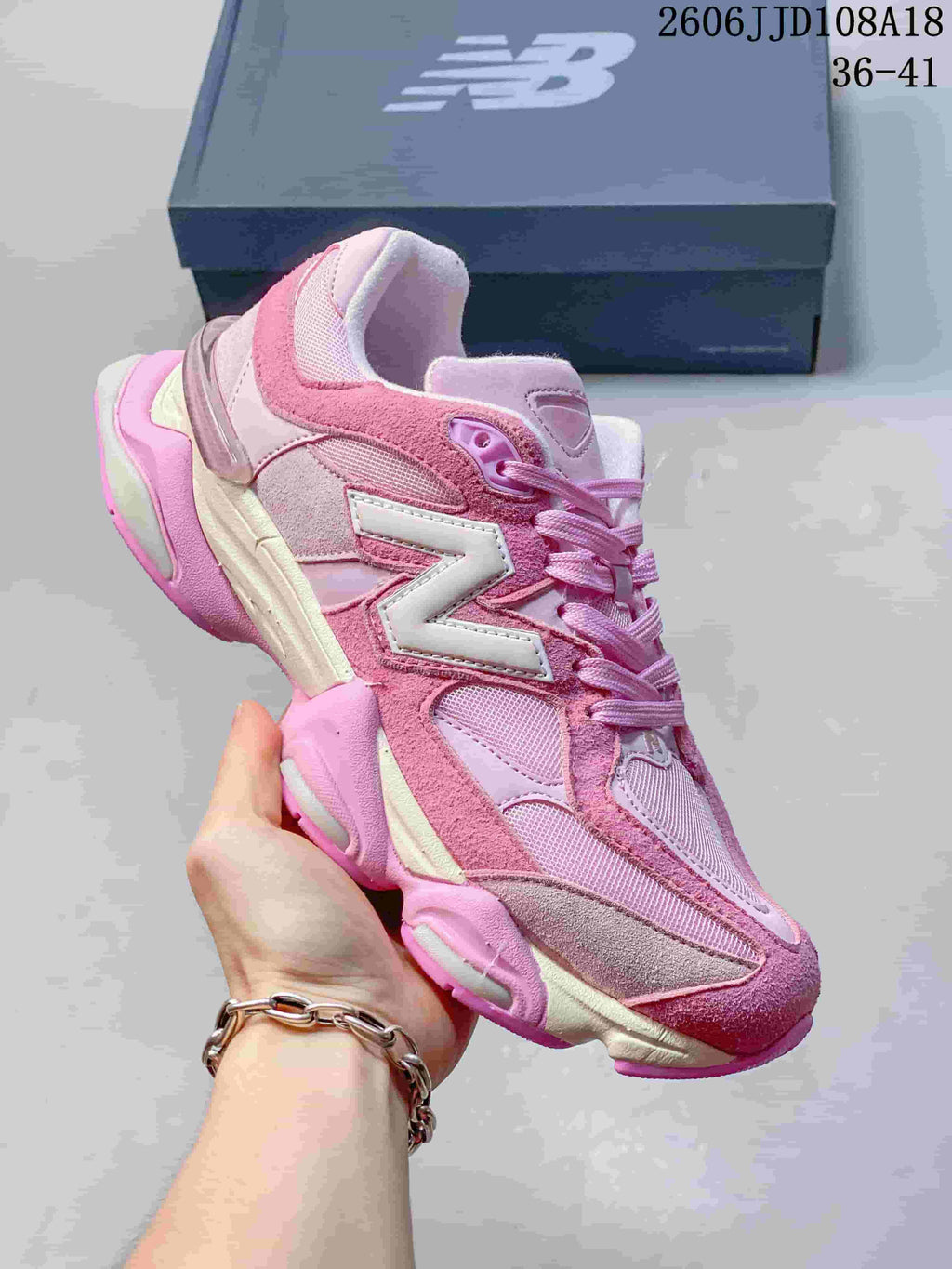 Close side view of a pink sneaker with a white N logo
