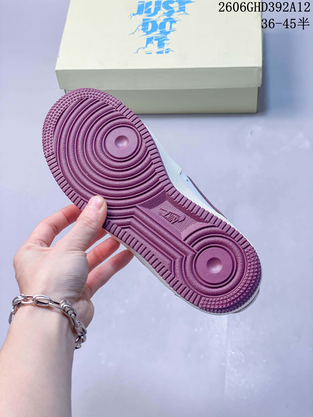 Underside of the sneaker showing a burgundy outsole
