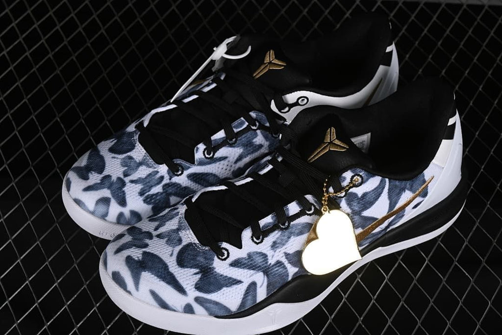 Pair of Nike Kobe 8 Protro shoes with patterned uppers and gold accents.