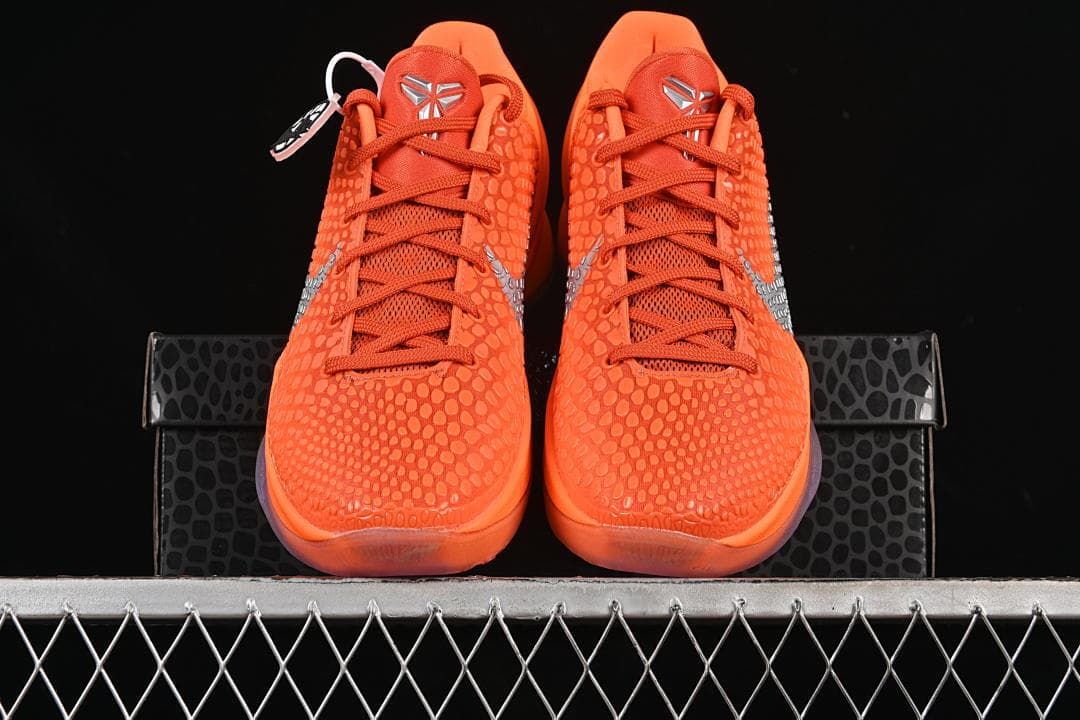 Front view of orange basketball shoes with silver details