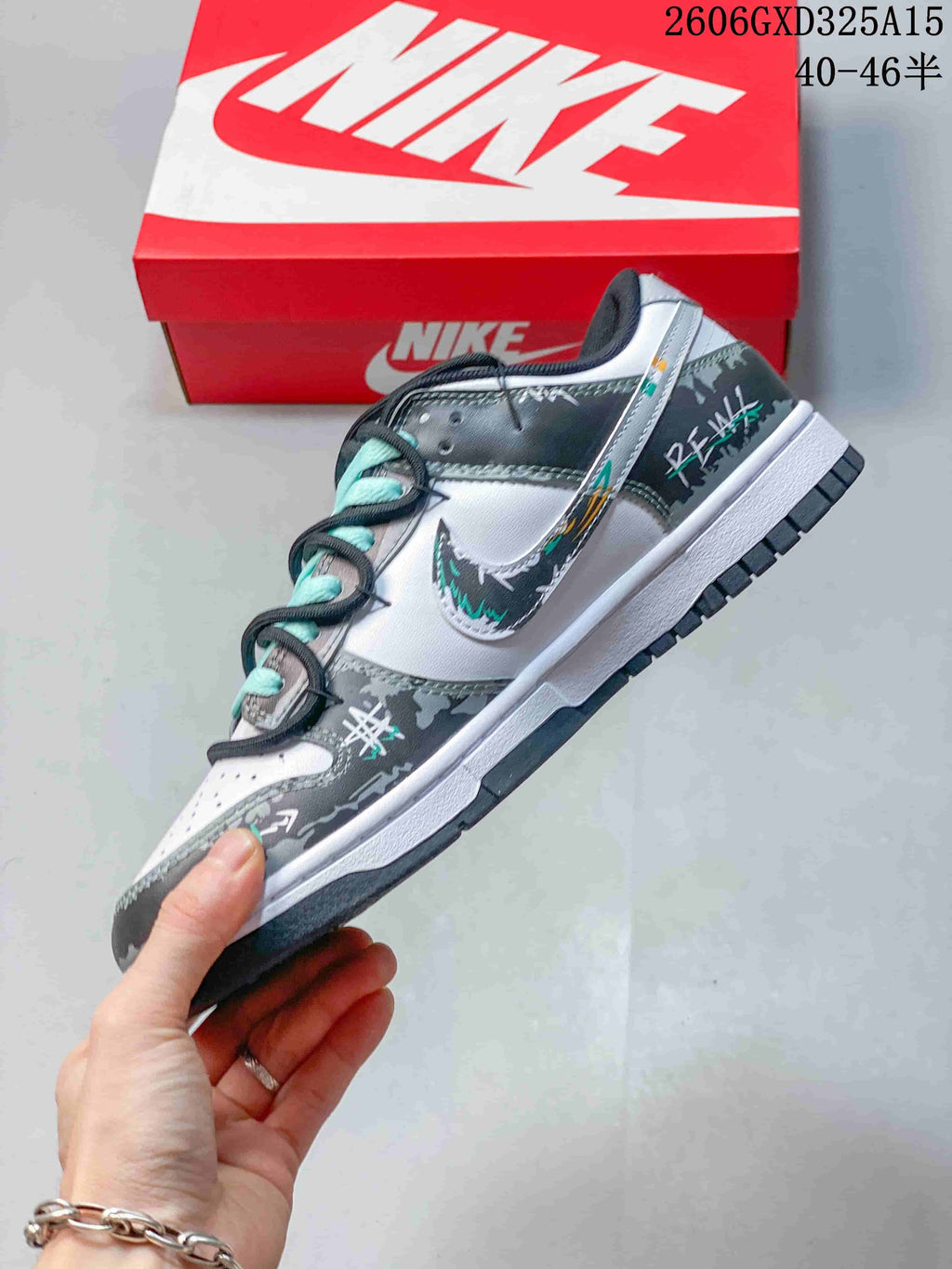 Angled side view of the white and gray low-top sneaker with graphic overlays