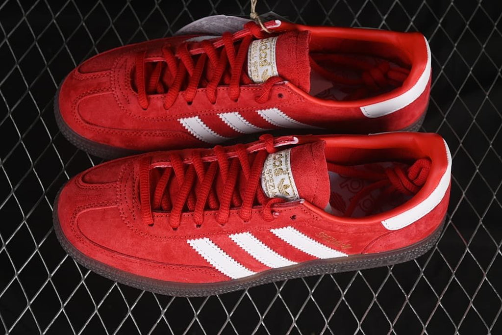 Top-down view of the pair of red sneakers with white stripes