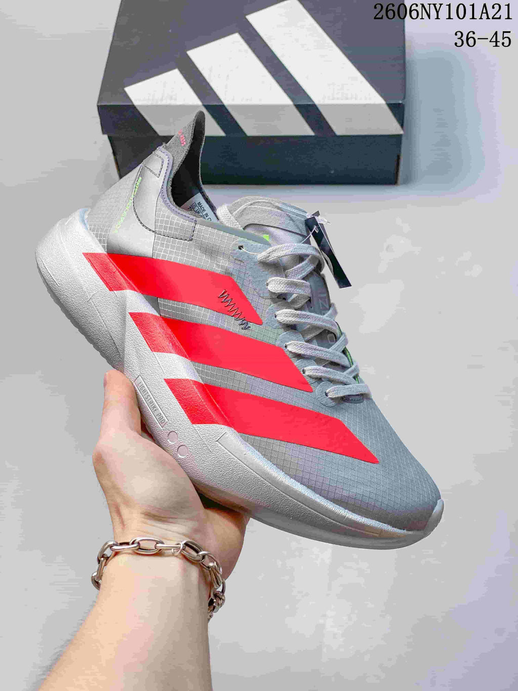 Gray Adidas running shoe with bright red stripes and Lightstrike Pro sole; image text shows 36–45.