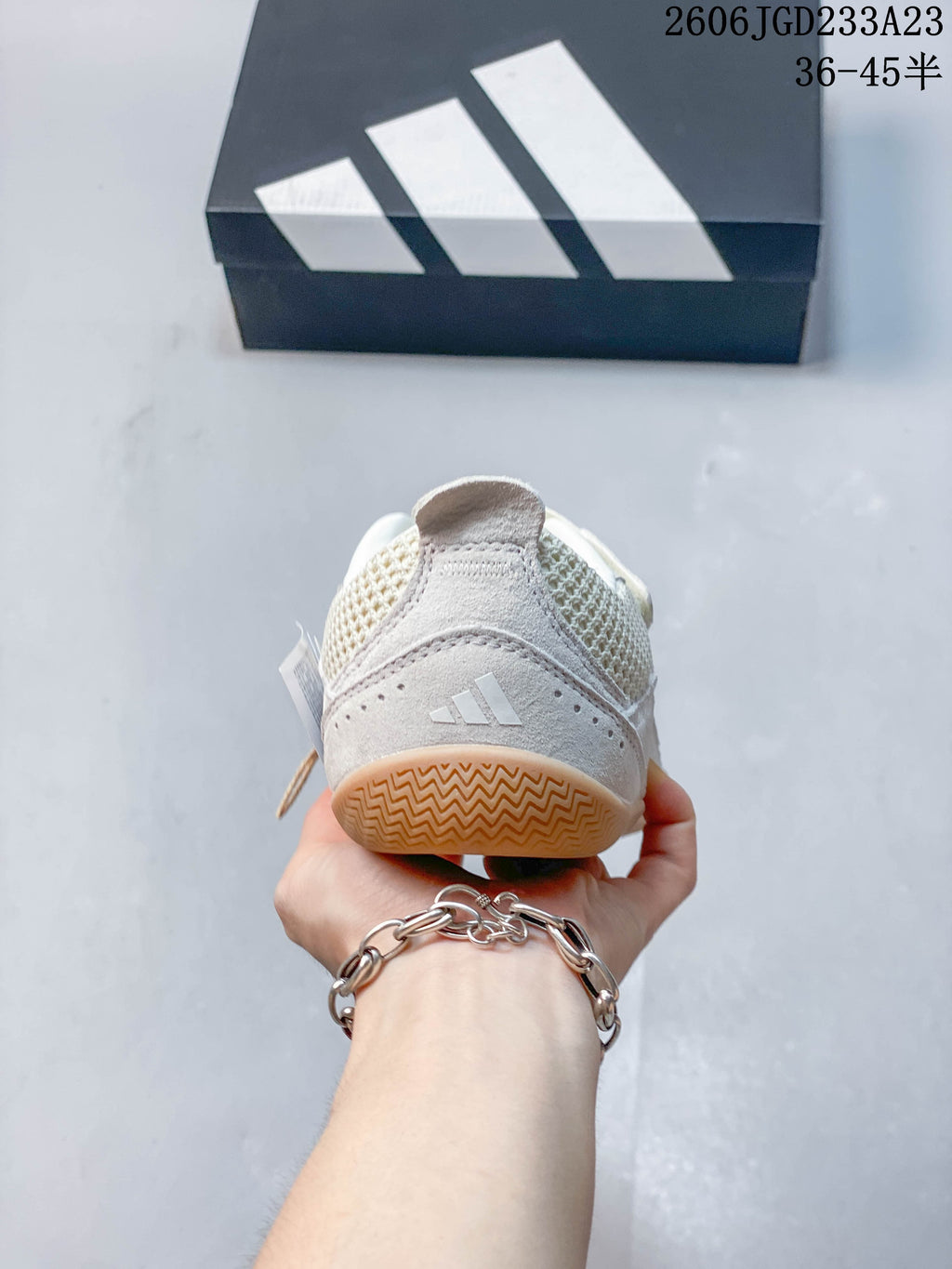 Rear view showing the heel panel and logo detail on an off-white adidas Urban Reverie sneaker