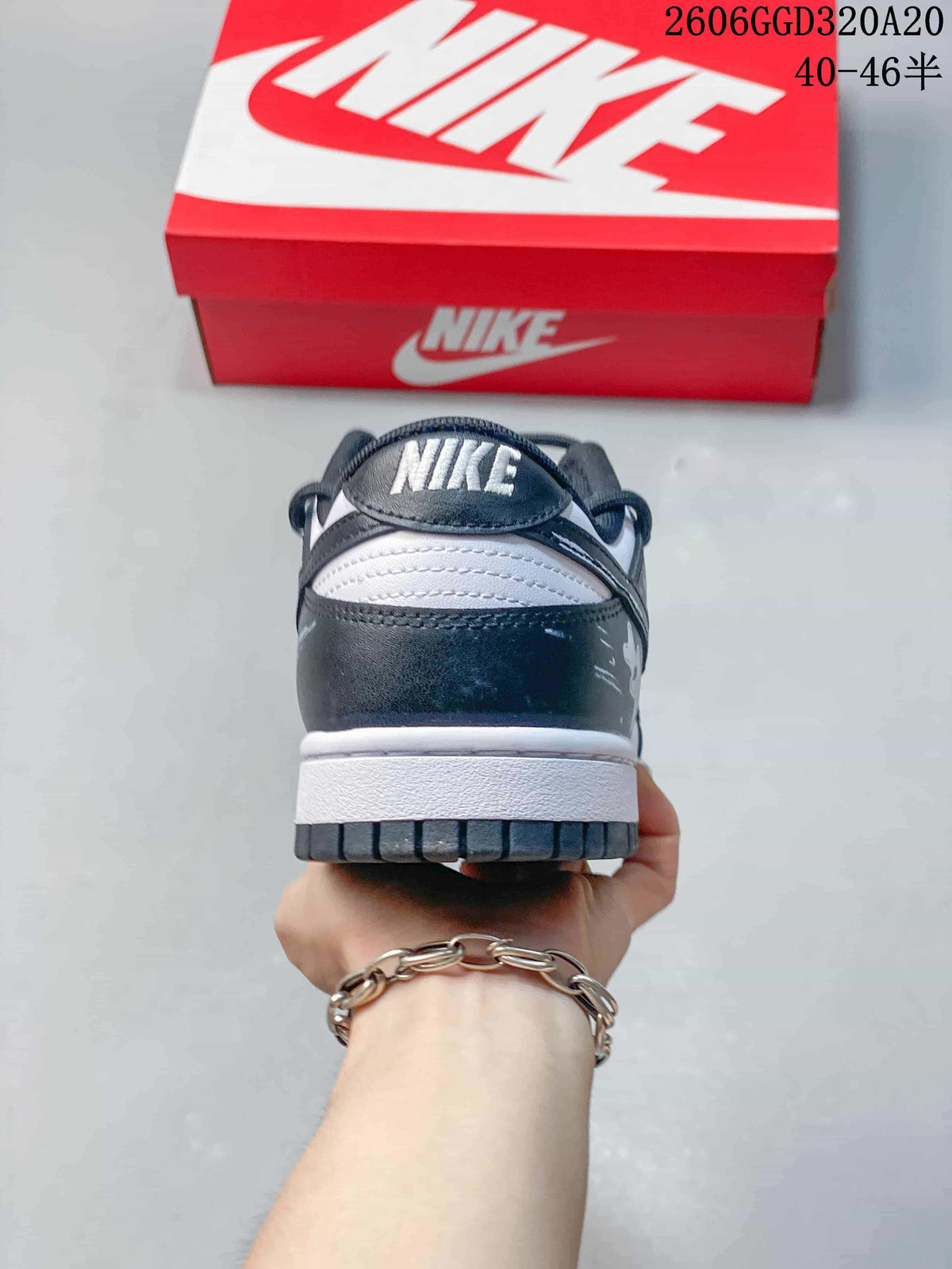 Rear view of a Nike Dunk Low Retro sneaker with a dark heel panel and white midsole