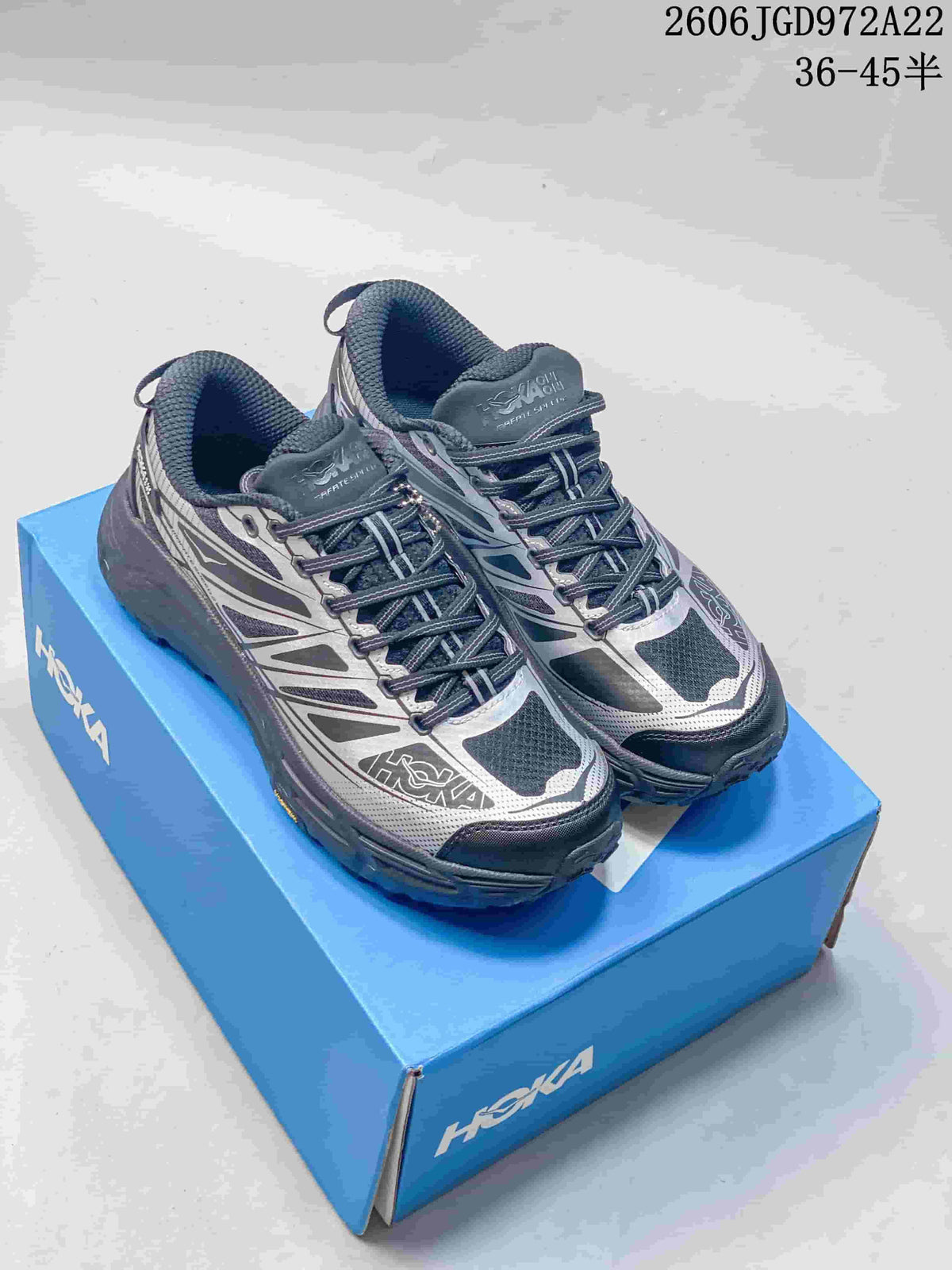Pair of dark navy and silver HOKA Mafate Speed 4 Lite shoes displayed on a blue shoebox; overlay lists sizes 36–45.5.