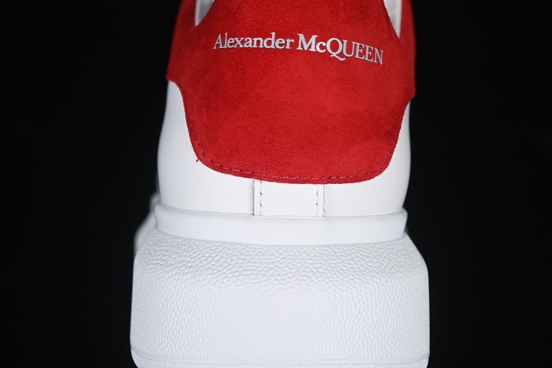 Rear view highlighting the red heel panel with Alexander McQueen branding.