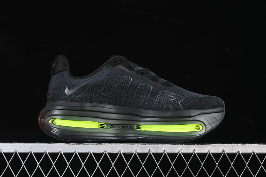 Side view of a black running shoe with a thick sole and bright volt-colored midsole accents.
