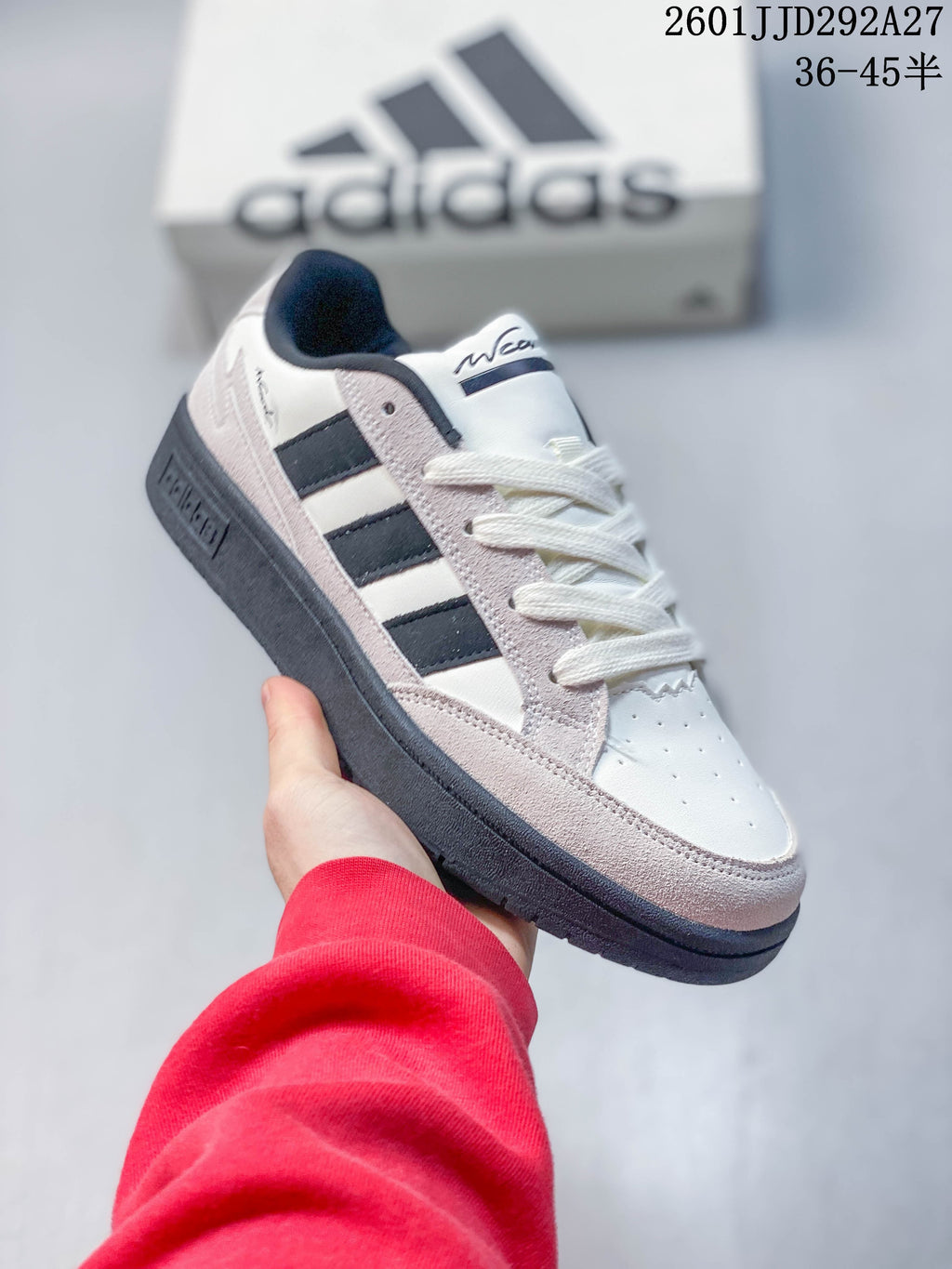 Angled side view of an Adidas Wcard Adv sneaker in white, light gray, and dark accents