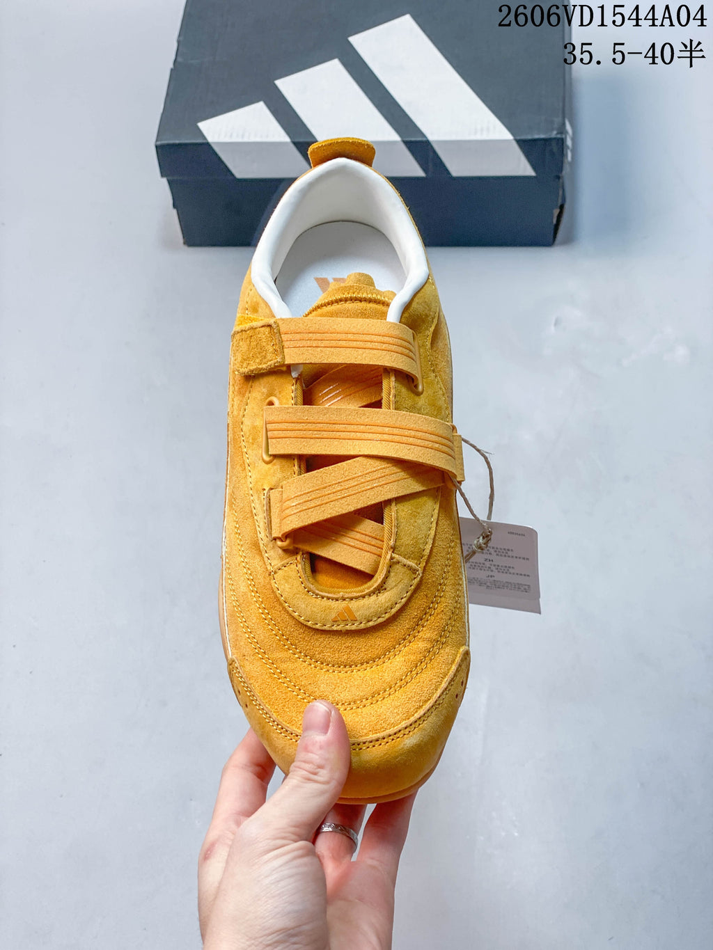 Top view of a golden yellow sneaker showing its broad strap-and-lace closure.