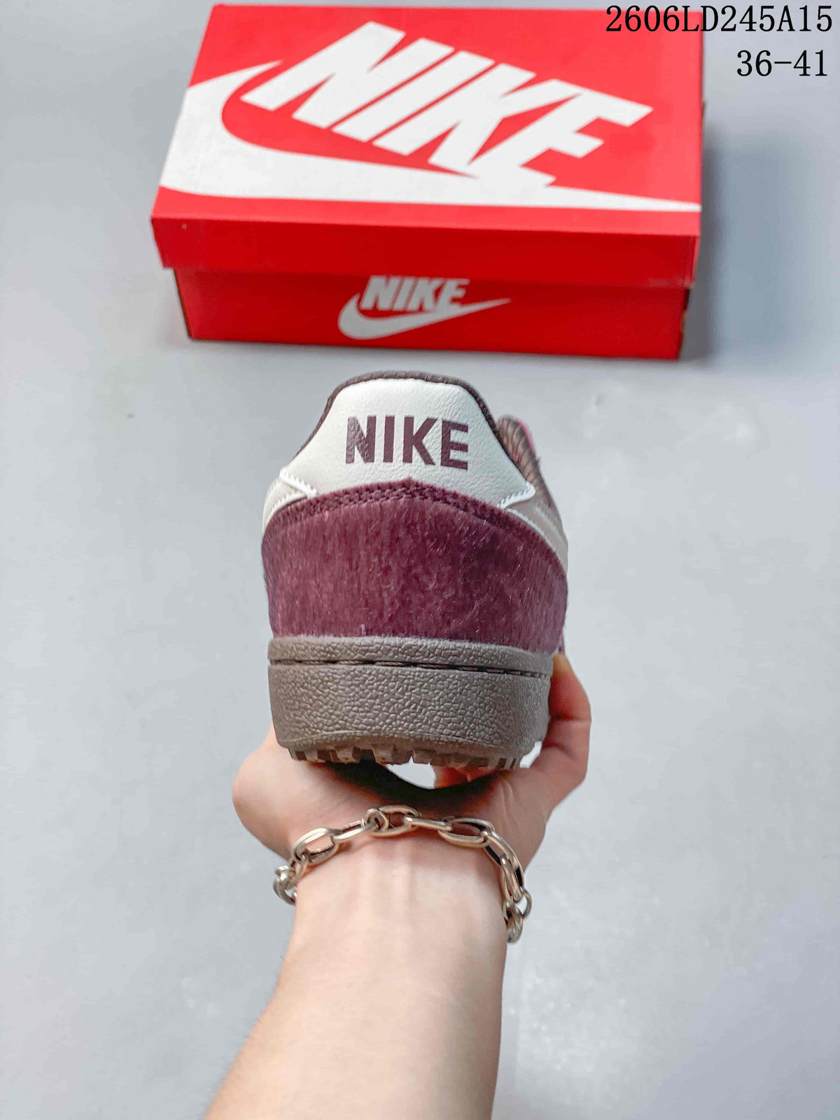 Rear view of the sneaker showing its burgundy heel panel and light-colored heel tab.