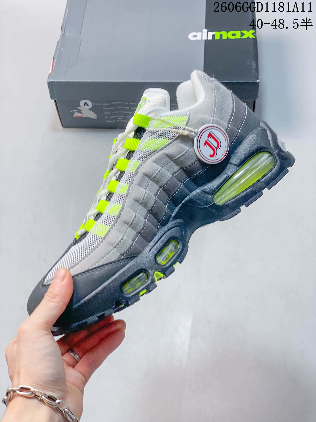 Side view of the grey and white sneaker with layered panels, volt details, and visible Air units.