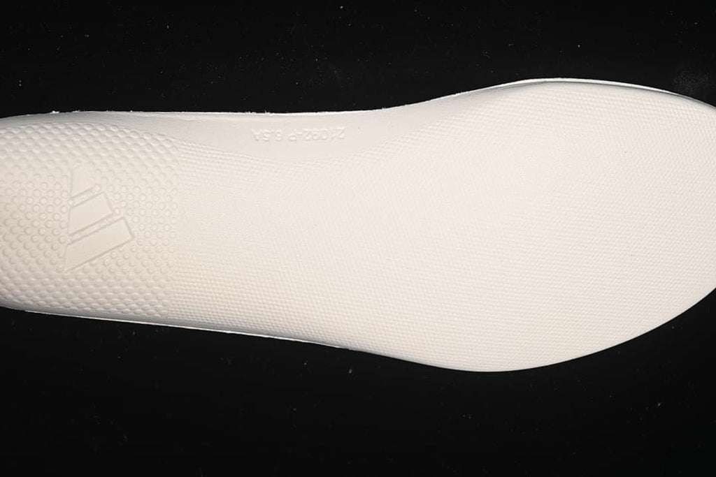 Close-up of the textured white midsole surface and Adidas logo