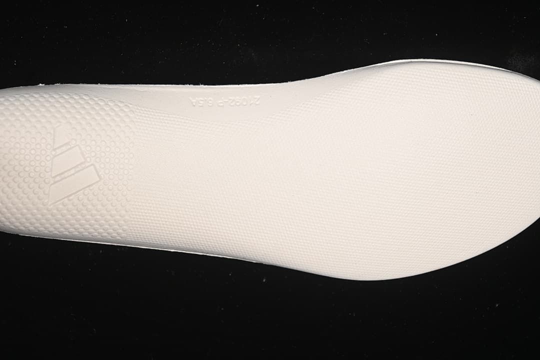 Close-up of the textured white midsole surface and Adidas logo