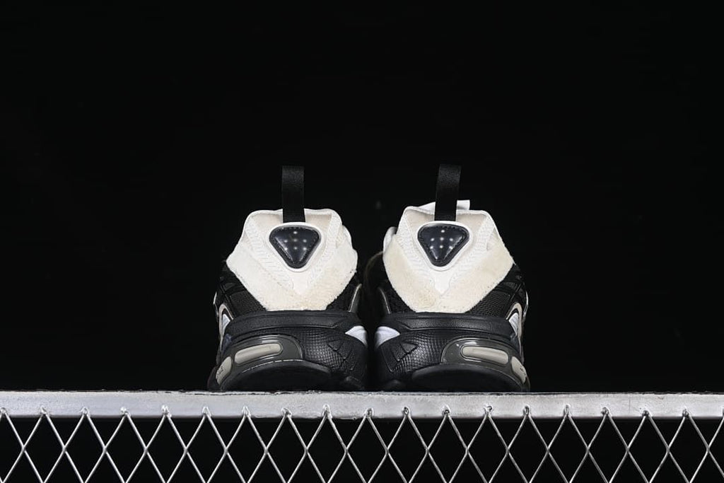 Rear view of the pair highlighting the off-white heel panels and pull tabs.