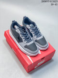 Pair of gray and black NikeCourt Borough 2 low-top sneakers on a red shoe box