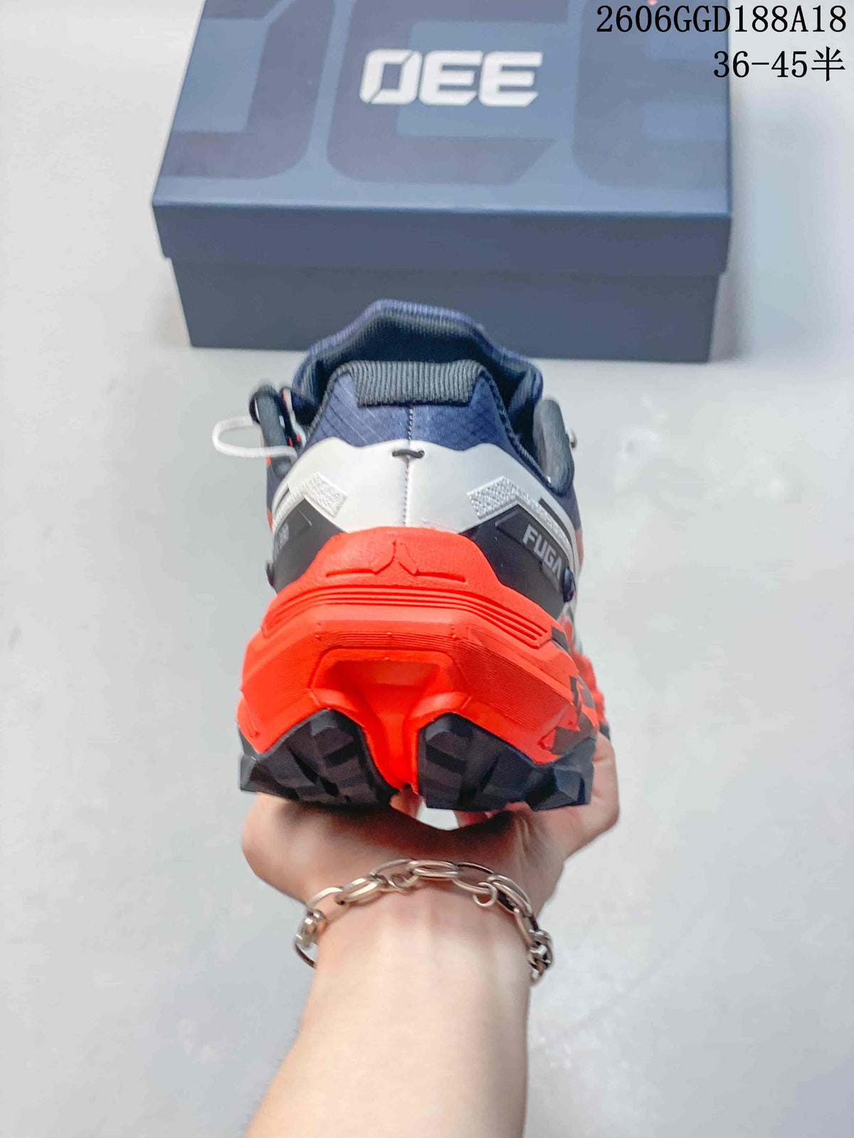 Rear view showing the orange heel and dark lugged outsole