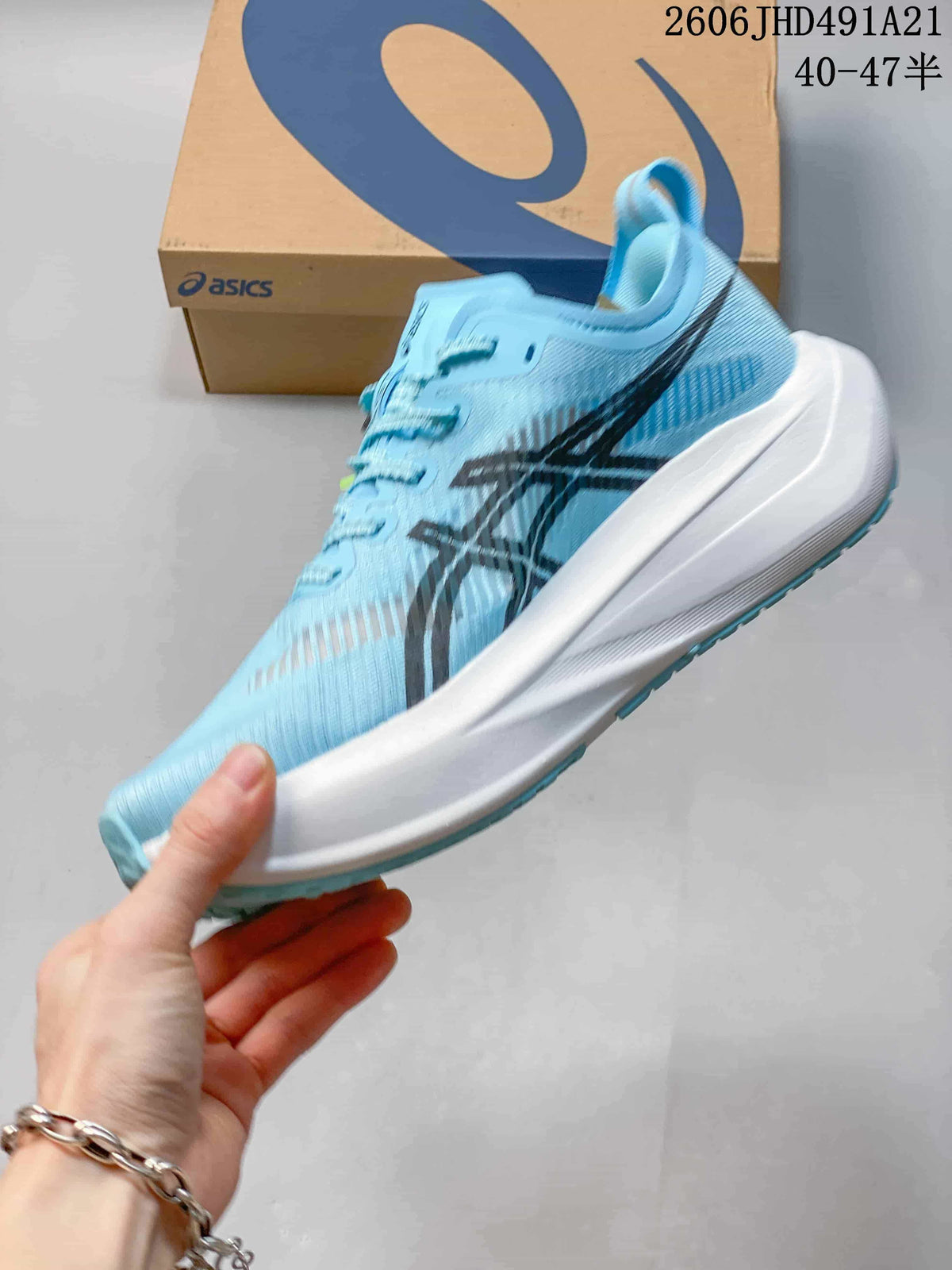 Side view of a light blue ASICS MEGABLAST running shoe with dark stripes