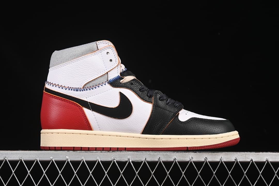 Side profile showing the black, white, and red upper with cream midsole