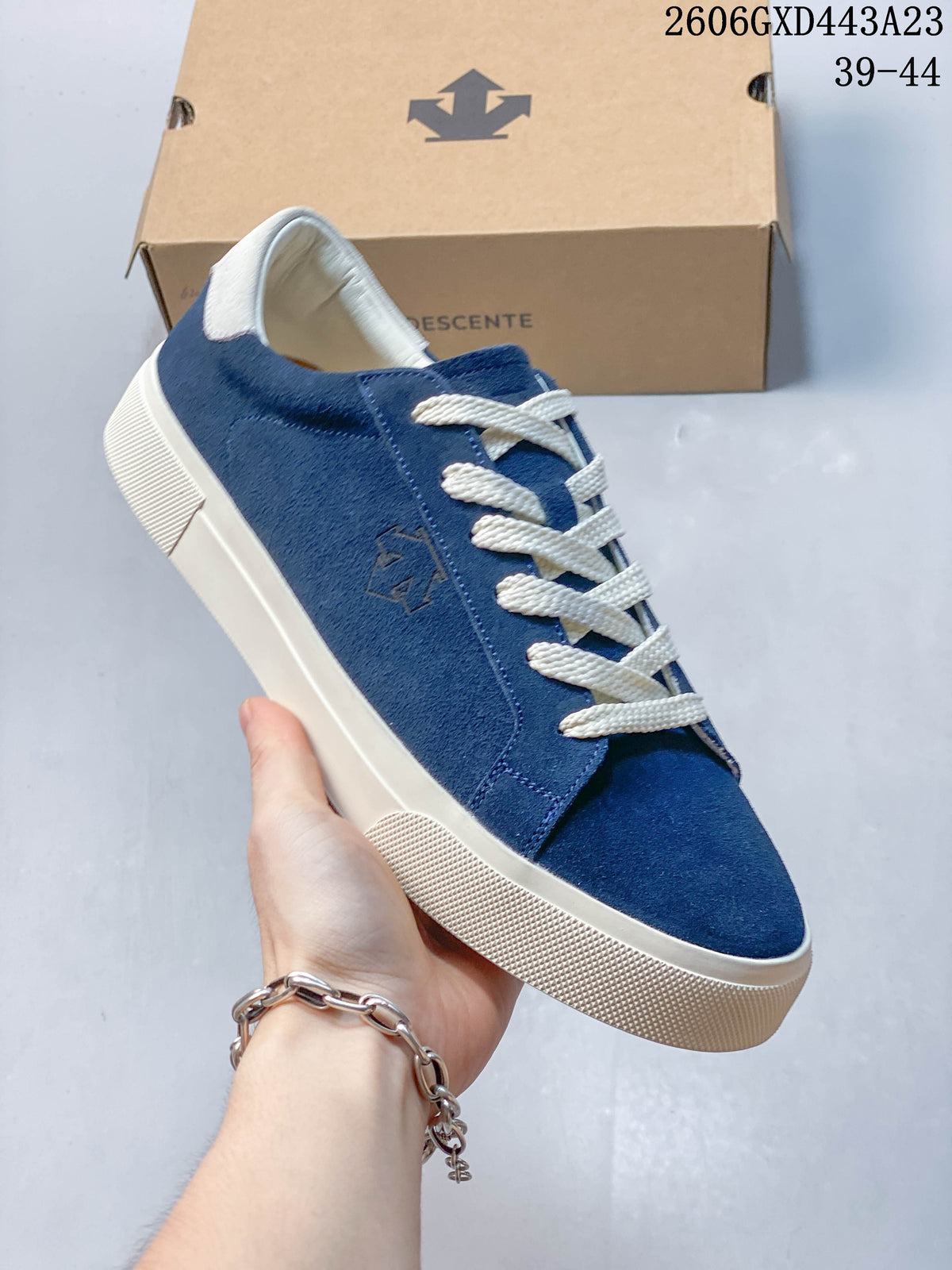 Close view of the navy sneaker's T-toe front, cream laces, and light-colored sole.