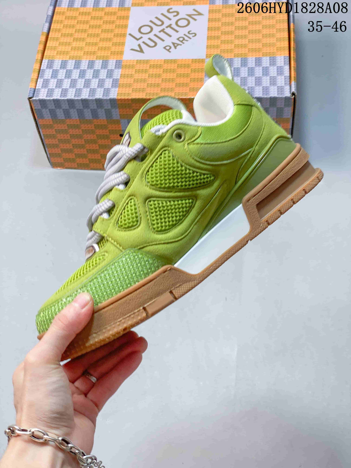 Side profile showing mesh panels, layered construction, and gum-colored outsole