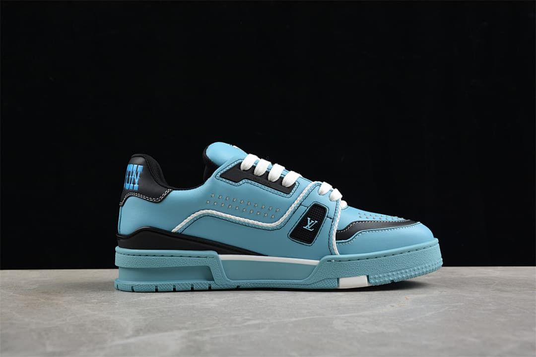 Side profile of a blue LV Trainer sneaker with navy trim and a layered sole