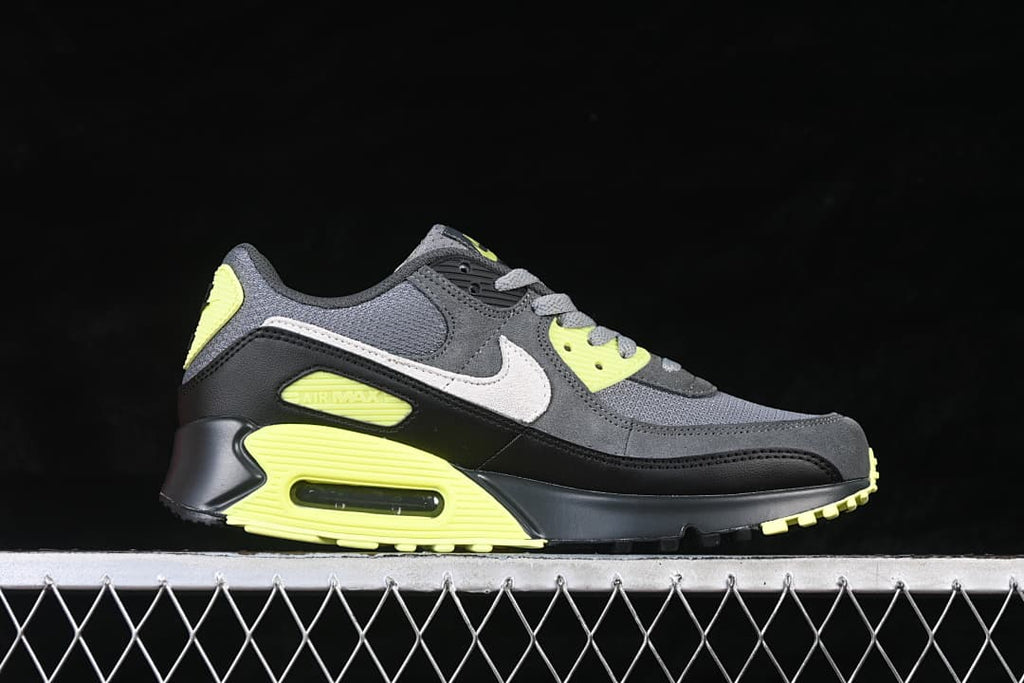 Side view of the Nike Air Max 90 in grey, black, white and volt.
