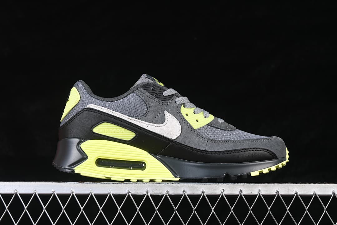 Side view of the Nike Air Max 90 in grey, black, white and volt.