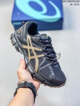 Angled side view of the dark navy ASICS Gel-Kahana 8 FL sneaker with gold-toned branding details.
