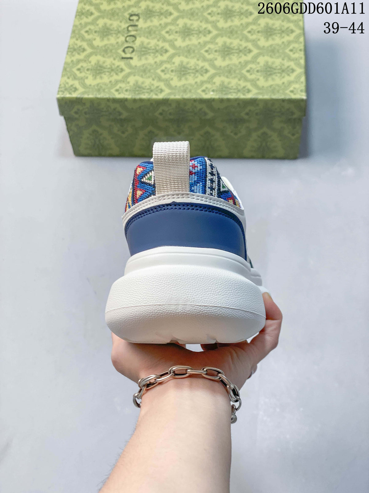 Rear view showing the blue heel panel and embroidered collar of the sneakers.