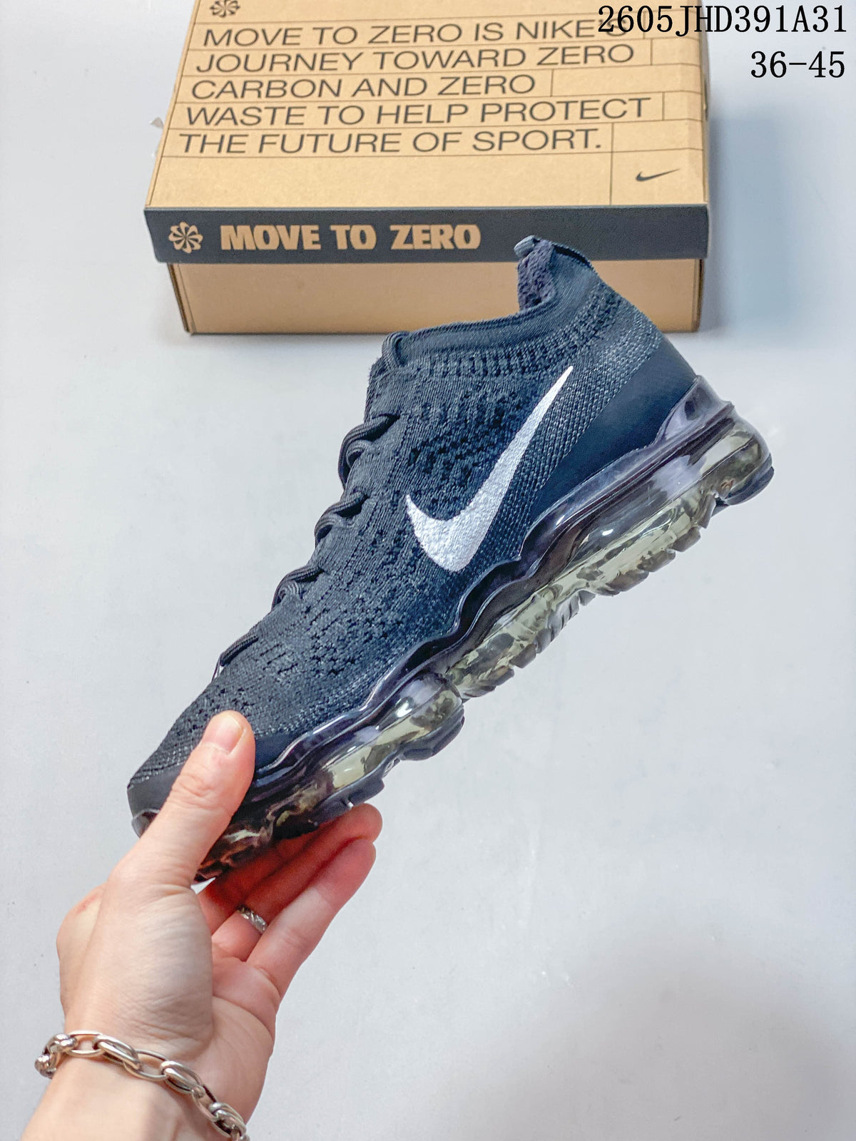 Side view of a dark blue Nike Air VaporMax shoe with a white Swoosh and visible Air sole