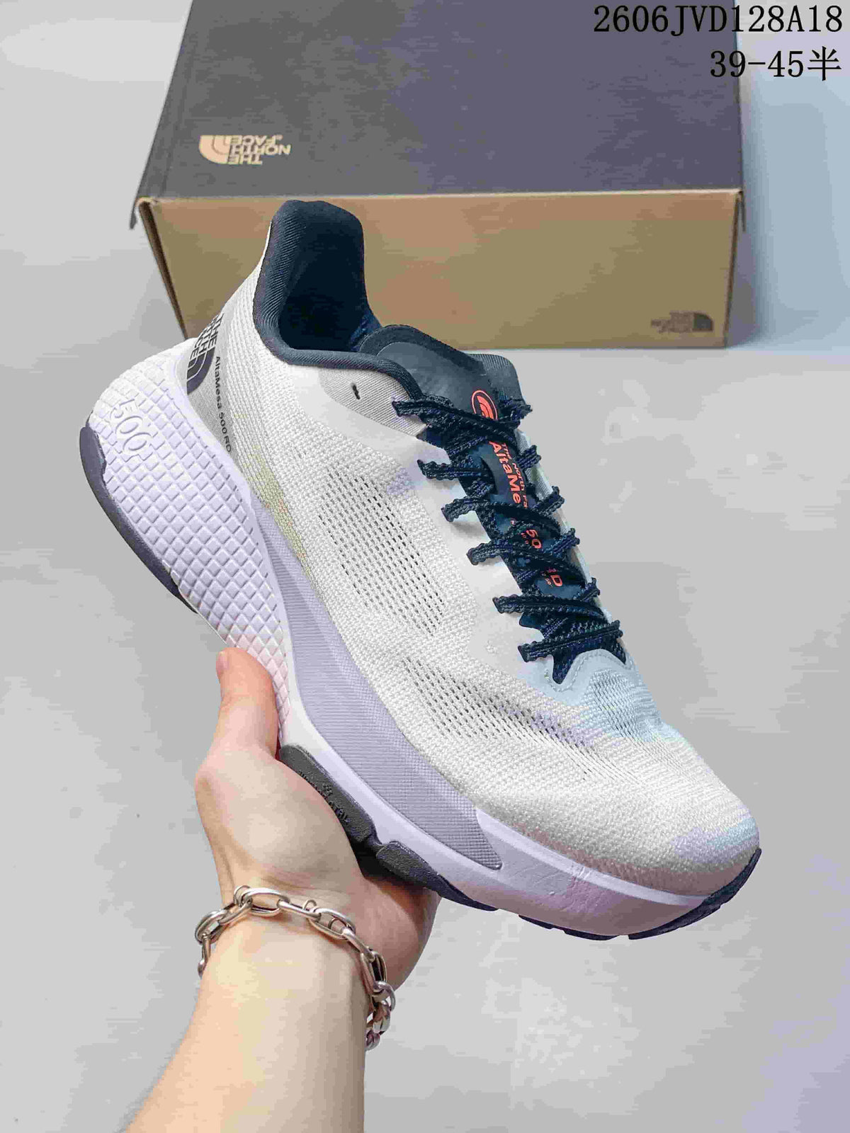 Side view of a white Alta Mesa 500 running shoe with navy laces and a pale lavender textured sole.