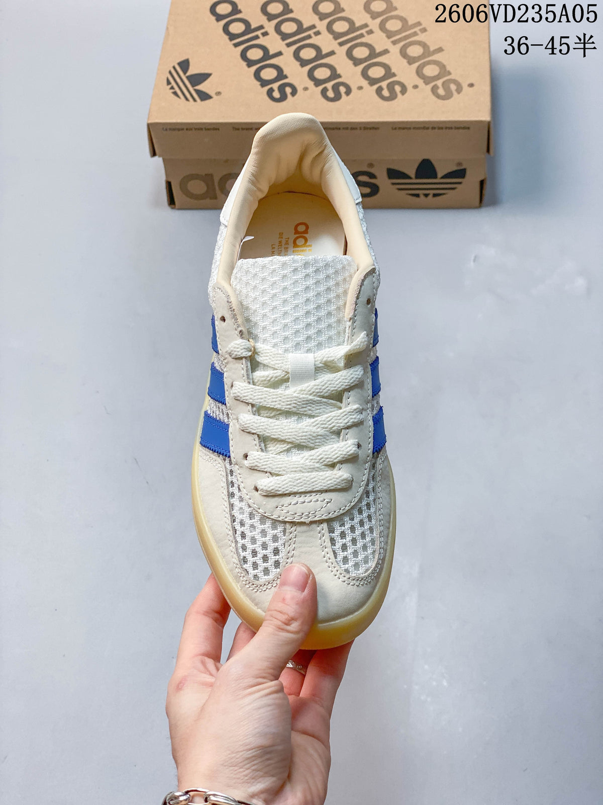 Front view of a lace-up sneaker with a textured toe and blue side stripes