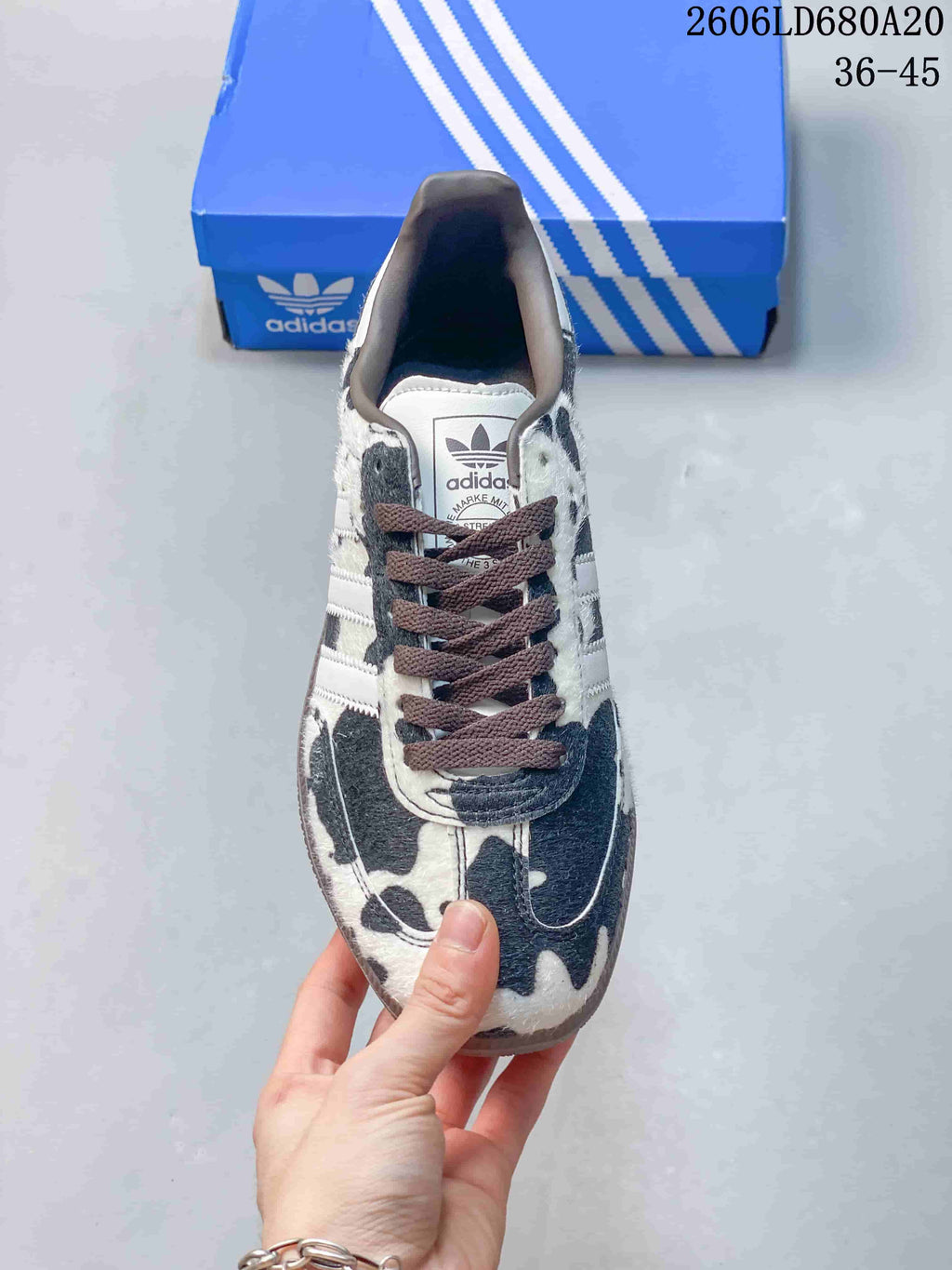 Top view of a cow-print sneaker with dark laces