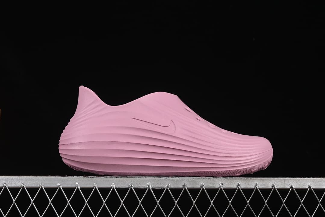 Side profile showing the raised heel, ridged shape and logo.