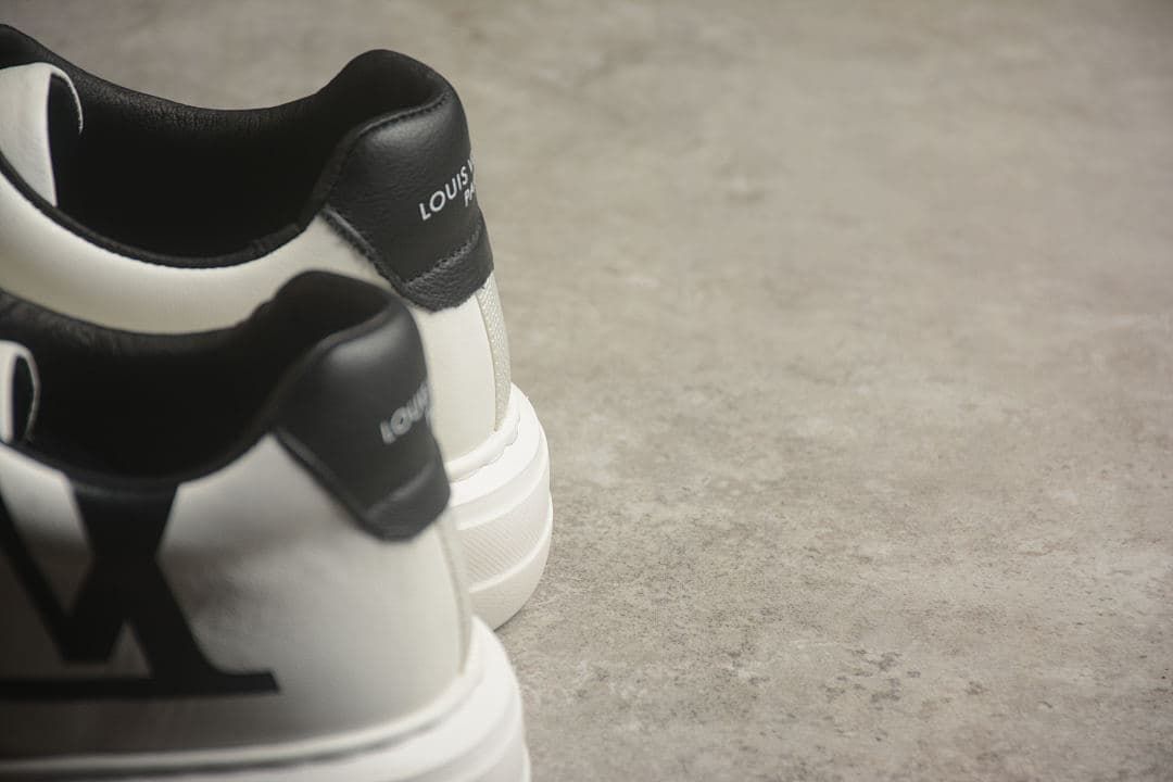 Rear view of the pair showing black heel panels, white uppers, and thick soles