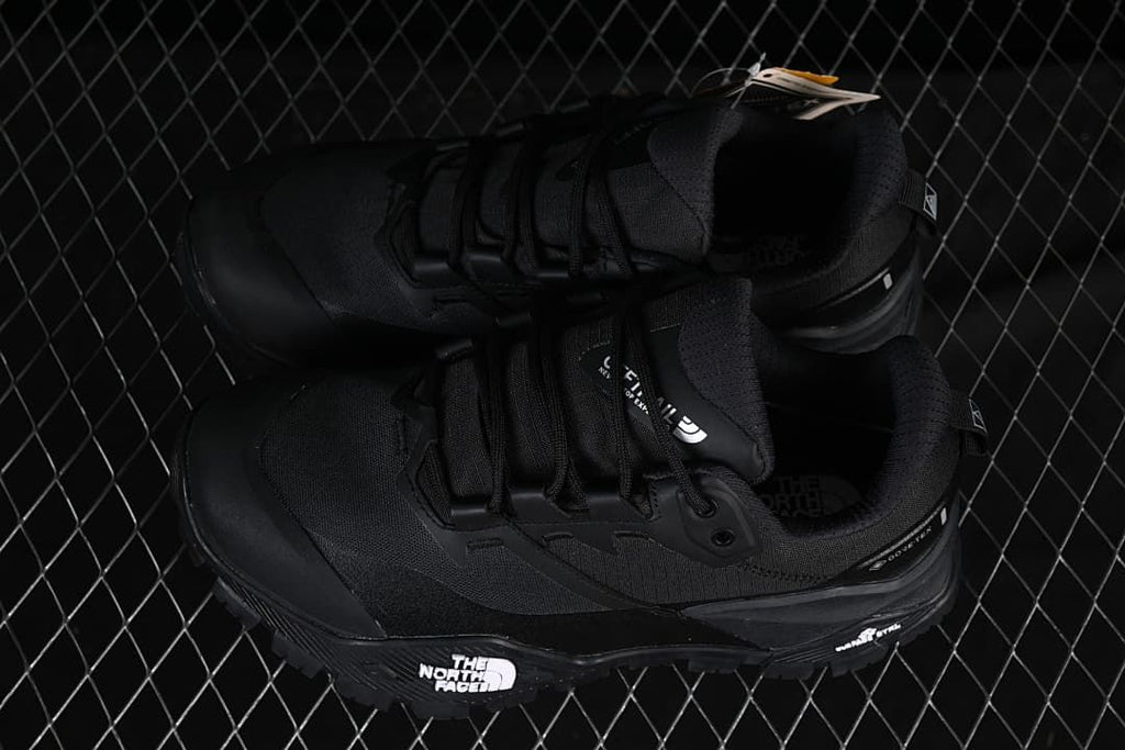 Pair of black hiking shoes displayed from above and the side