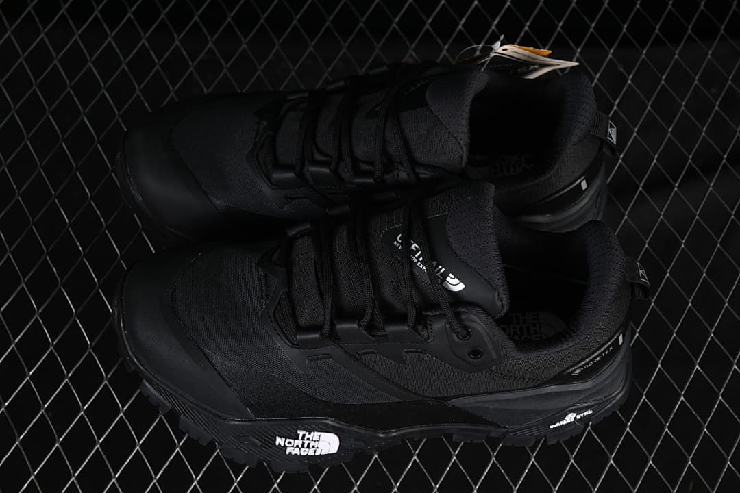 Pair of black hiking shoes displayed from above and the side