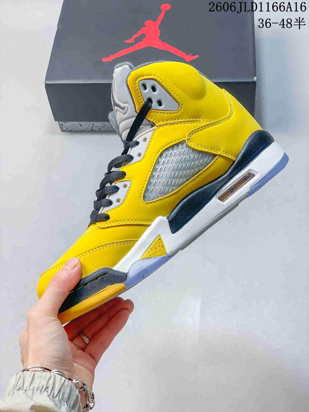 Side view of a yellow Air Jordan 5 Retro sneaker with mesh panels and translucent outsole