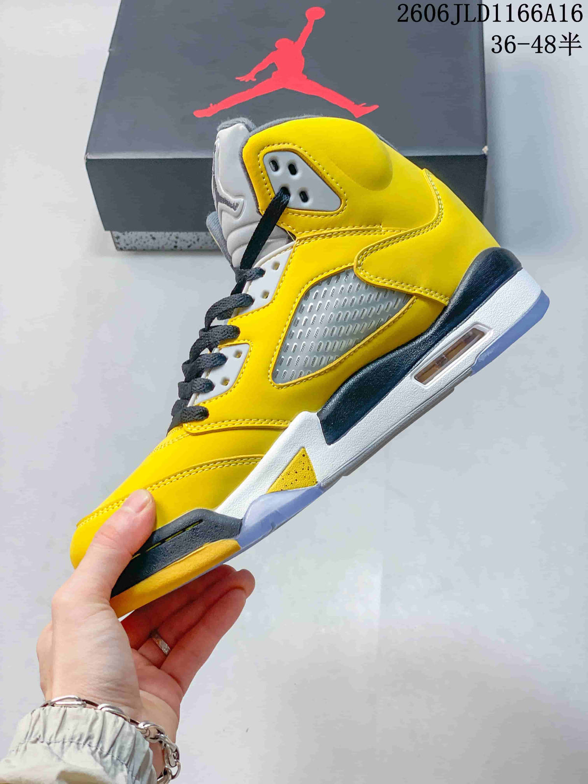 Side view of a yellow Air Jordan 5 Retro sneaker with mesh panels and translucent outsole