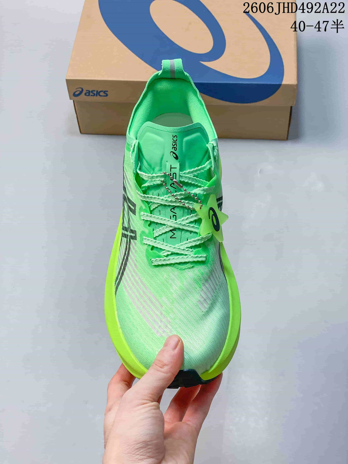 Top view of a green lace-up running shoe with patterned upper and dark side stripes