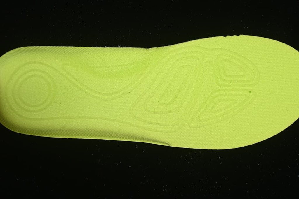 Bright lime-colored insole or footbed shown by itself.