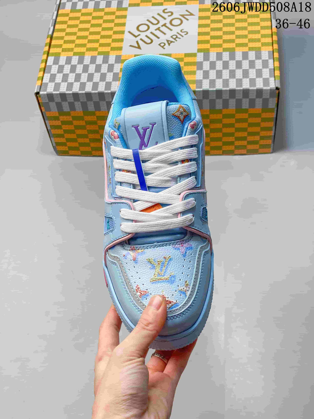 Top view of the sneaker showing white laces and multicolored patterned panels
