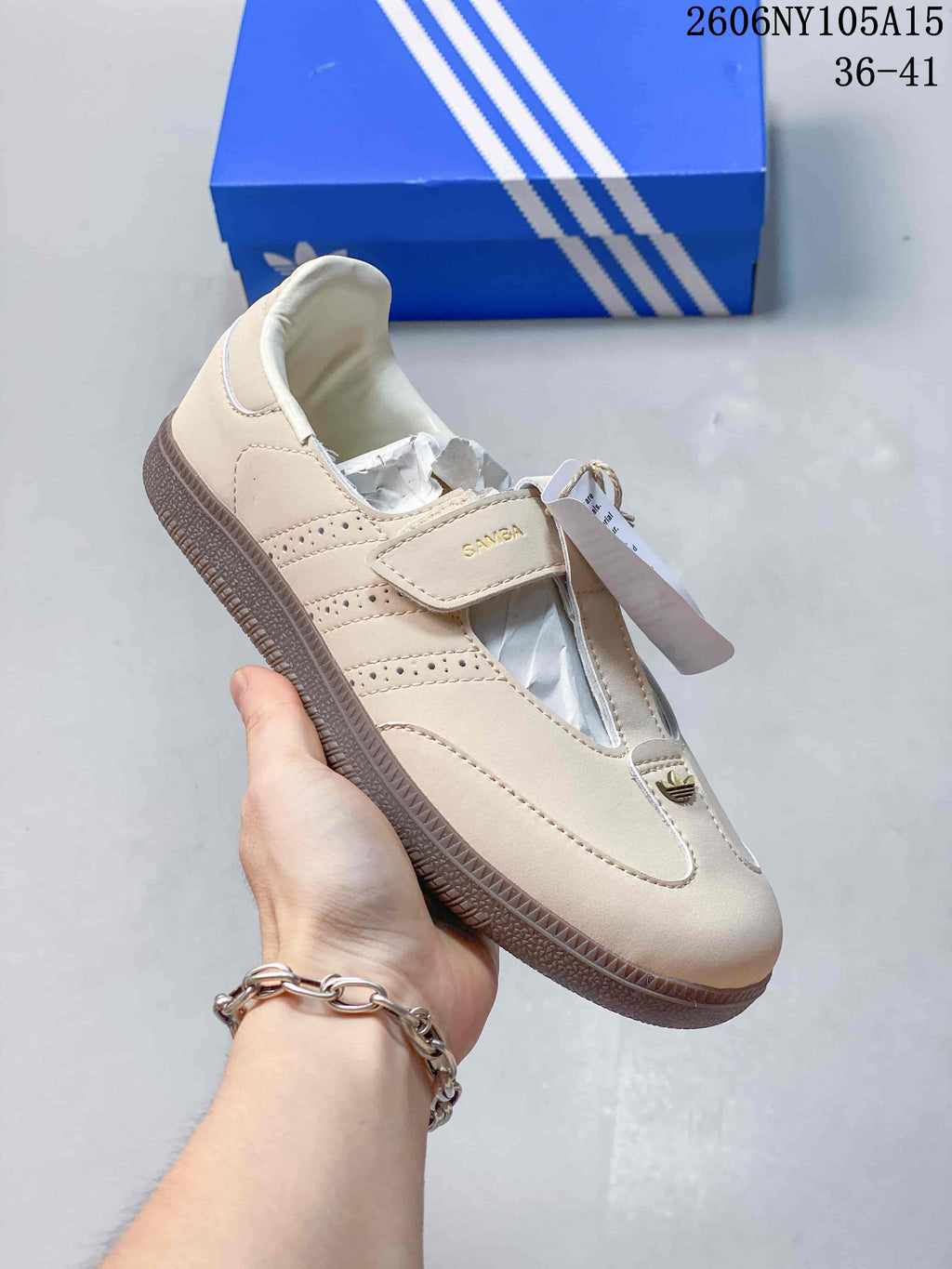 Angled view of the beige Samba Jane sneaker, highlighting its strap and perforated side stripes.
