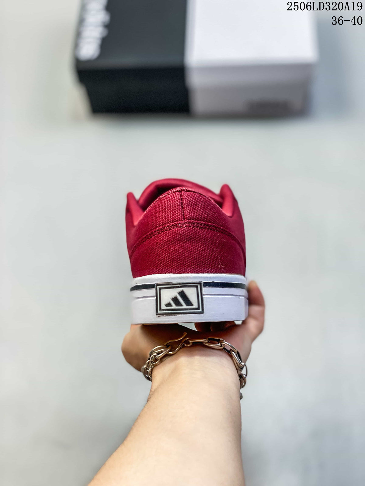 Rear view of the burgundy sneaker showing its heel and white sole.