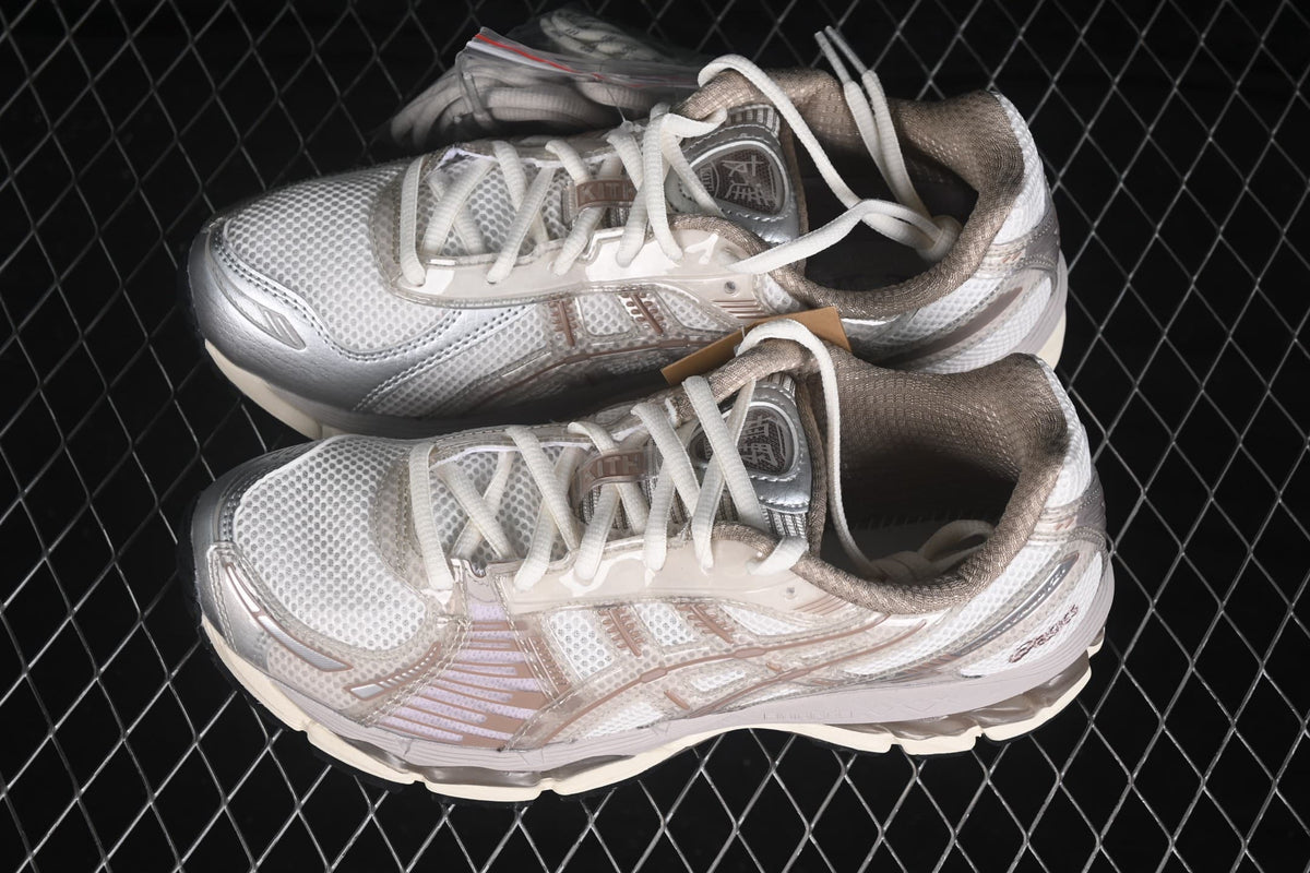 Top-down view of the pair showing the mesh toe boxes, layered side panels, laces, and contrasting cream and gray details.