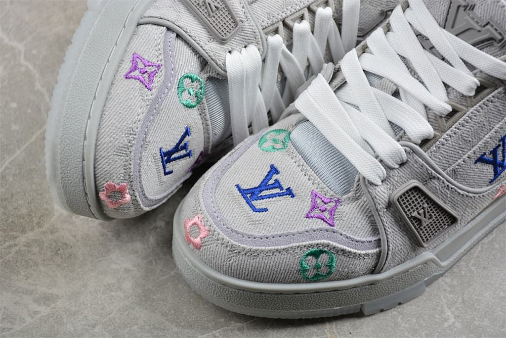 Close-up of colorful embroidered motifs on the gray sneaker toe