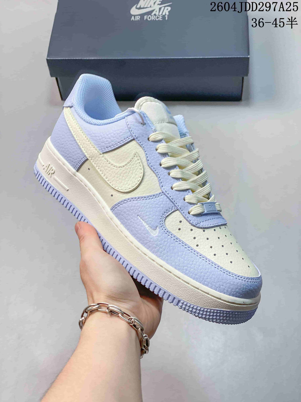 Angled side view of a light blue and cream Nike Air Force 1 ’07 LV8 sneaker