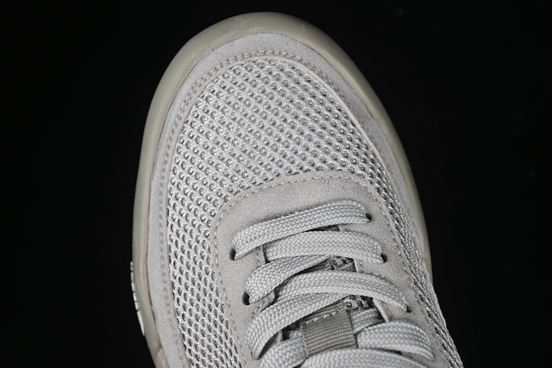 Top-down close-up of the sneaker's mesh-style toe and lacing.