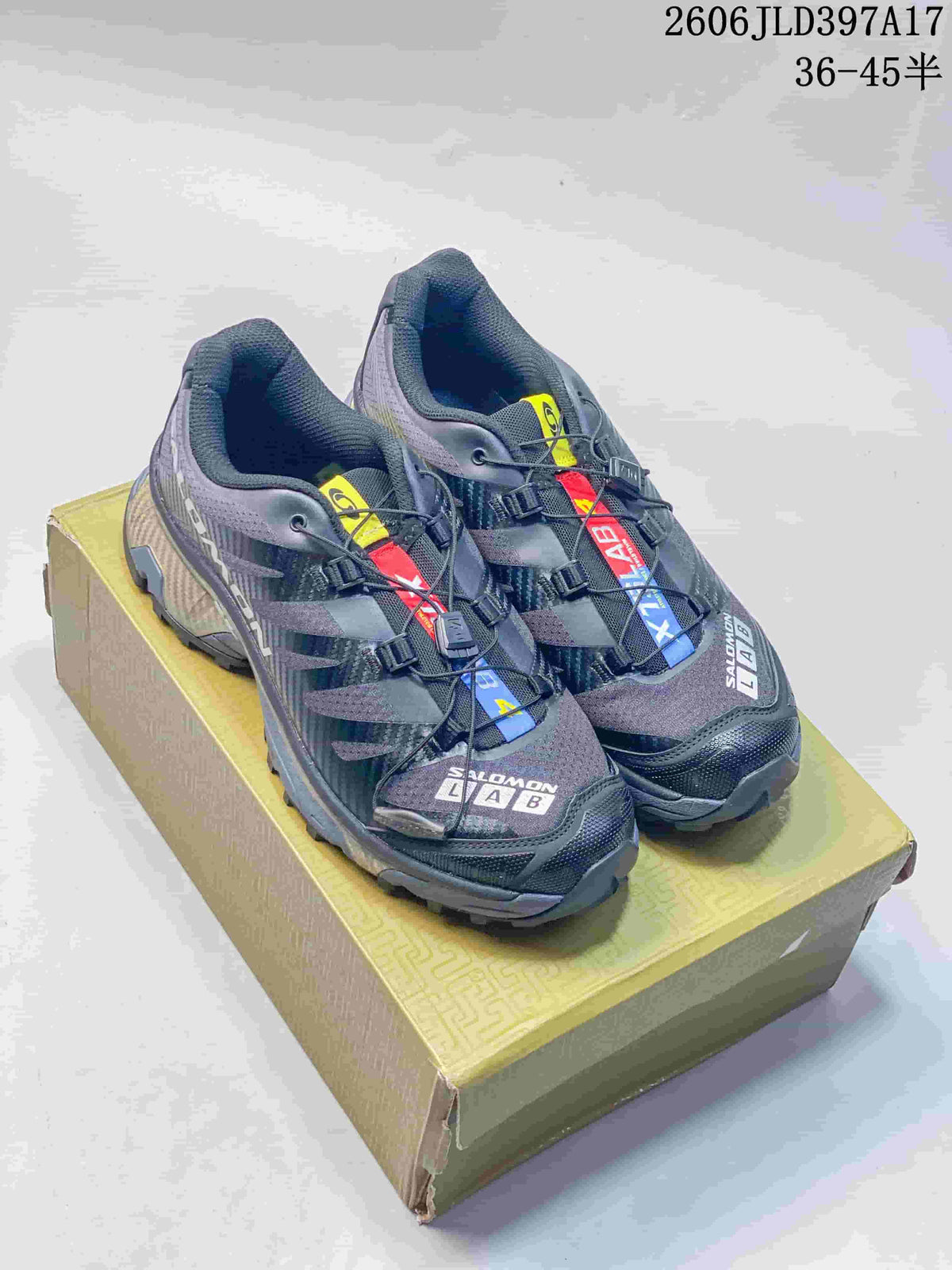 Pair of dark gray Salomon XT-4 OG sneakers shown from above on a box